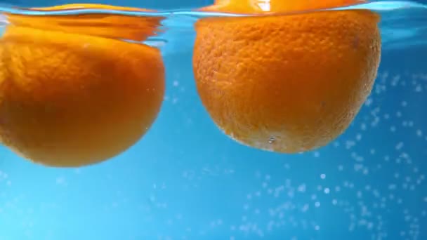 Orange dans l'eau avec des bulles d'air. Laver les fruits — Video