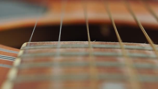 Guitar strings and frets for making music. Selective focus on one guitar threshold. — Stock Video
