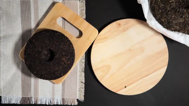 Chinese puer shu and shen in the form of pancakes. top view on a black background. copying for text — Stock Video