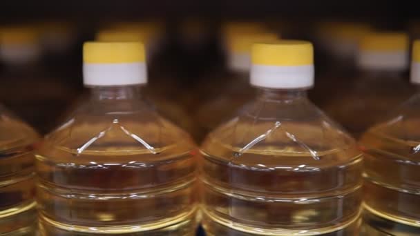 Plastic bottles with sunflower oil at the grocery store. Close-up. selective focus — Stock Video