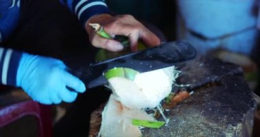 Hindistan cevizi Temizleme tekniği, kadın eller Cut Coconut Machete. Kadın bir Hindistan cevizi pişirir, onu Içmek için bir Hindistan cevizi Cuts. 4k