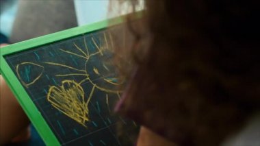 Sanatçının Genç Elleri, Küçük Çocuk Sanatçı Grafit Kalemler ile Bir Tuval Boyar, Bir Masa Oturma ve Tuval üzerine çizin. Çizim Süreci: Sanatçılar Sanat Stüdyosu El Bebek Kız Tuval üzerine Çizim.