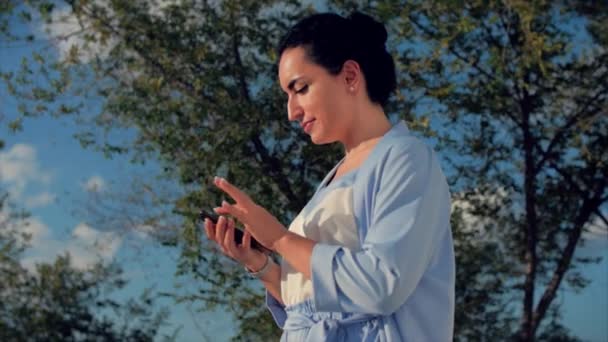 Attractive Woman Brunette in a Blue Suit With use of mobile phone. Business Woman use of mobile phone. — Stock Video