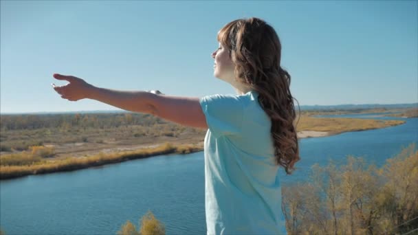 Portrait of a European woman or girl raising her face to the sun. A woman receives vitamin D from the sun — стокове відео