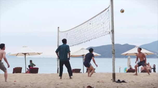 Después de cuarentena de aislamiento. Covid-19. Amigos jugando voleibol playa al atardecer, pico de voleibol en el cinemático Nha Trang, Vietnam, 14 de mayo 2020 . — Vídeo de stock