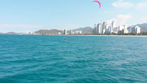 Jump acrobatic of professional kite surfer on the sea wave, athlete showing sport trick jumping with kite and board in air. Extreme water sport and summer vacations concept. — Stock Video
