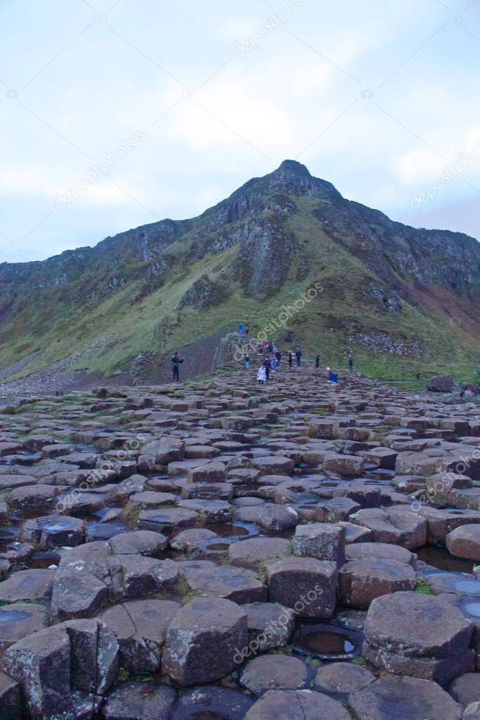 View of the Rocks of Giants Causeway Looking up with Tourists 