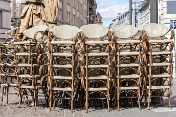 Rows of traditional Chairs of a Street Cafe in France, french furniture in a Street