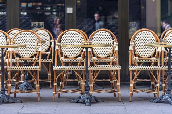 Rows of traditional Chairs of a Street Cafe in France, french furniture in a Street