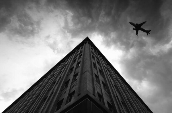 Airplane over Building in the City black and white creativity Picture