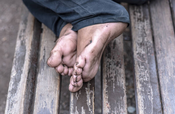 Homeless Man on Bench, close-up dirty Legs of Beggar 