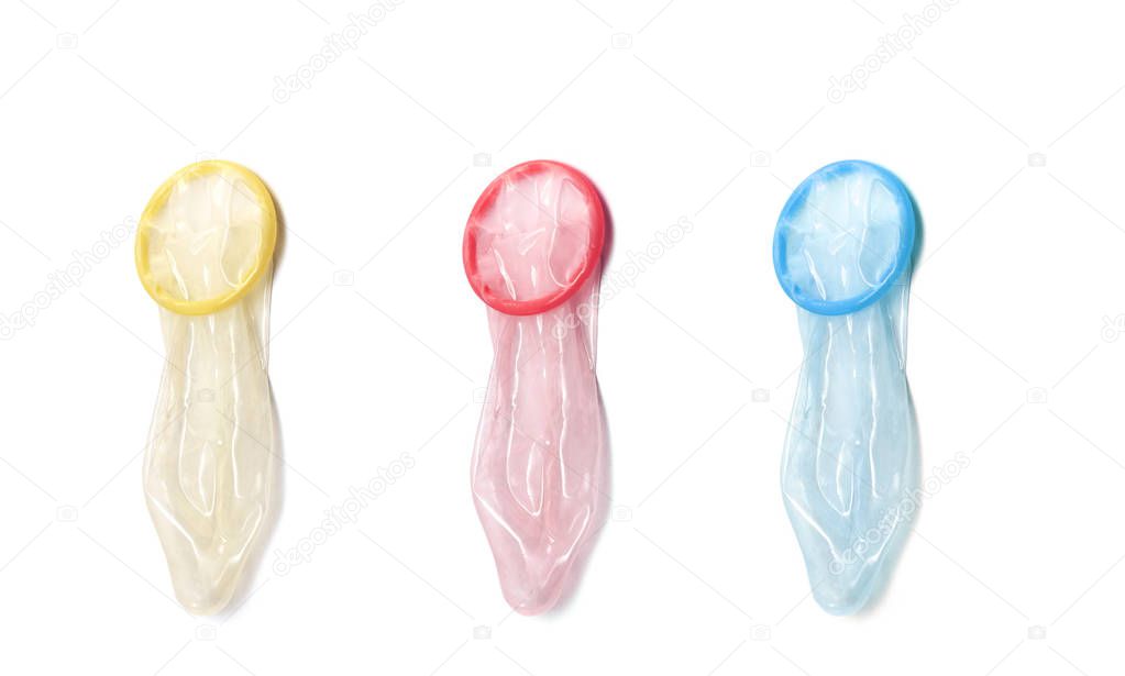 Three used Condoms red, yellow and blue isolated on white Background