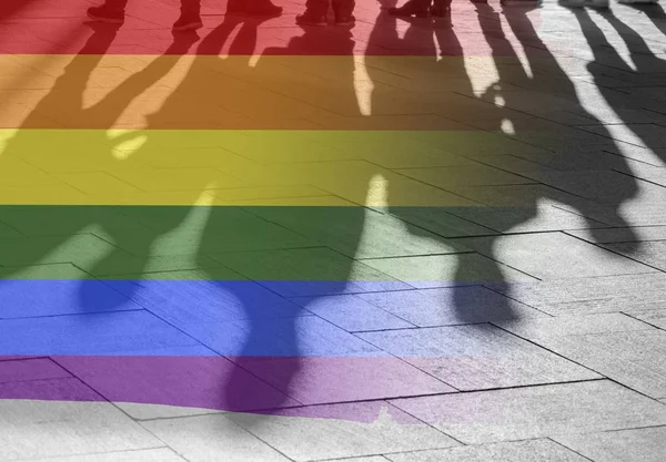 Gay Rights Shadows of People and Rainbow Flag as Symbol Right, Freedom - conceptual Picture about anonymous Gay Lesbian and Transgender in the World