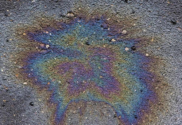 Oil stain on Asphalt, color Gasoline fuel spots on Asphalt Road as Texture or Background