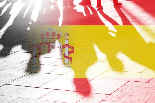 Spanish flag or flag of Spain as background and shadows of people, concept picture