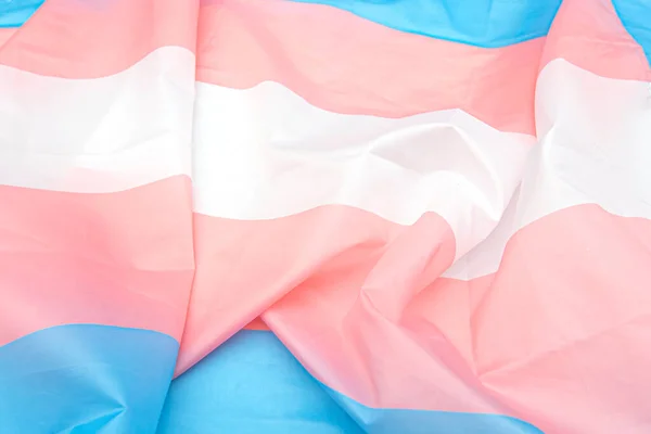 Beyaz, pembe, mavi şeritli transseksüel kumaş bayrağı. Arka plan veya doku olarak transseksüel gurur bayrağını kapat