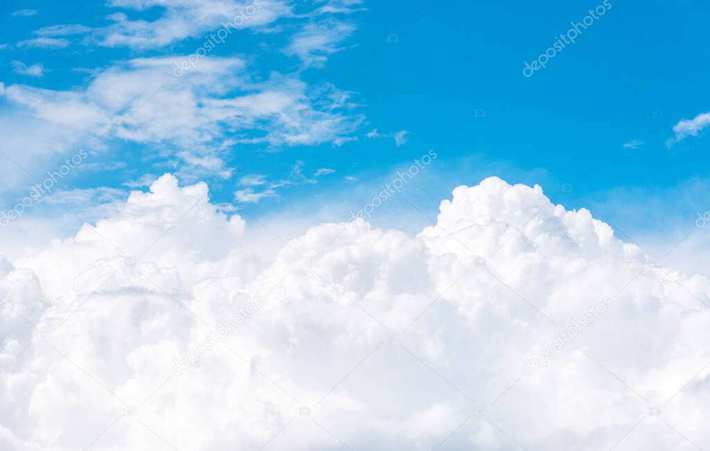Cumulus clouds on blue sky, view from airplane window