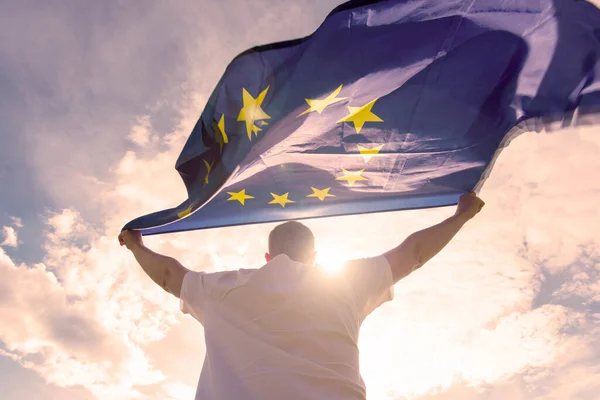 Man holding EU Flag or European Union flag, concept picture