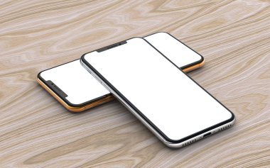 Ahşap arka planda izole edilmiş boş ekranlı gümüş ve altın akıllı telefonlar.