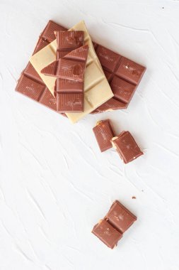 Beyaz ve sütlü çikolata. Fayans çikolata beyaz bir arka plan üzerinde.