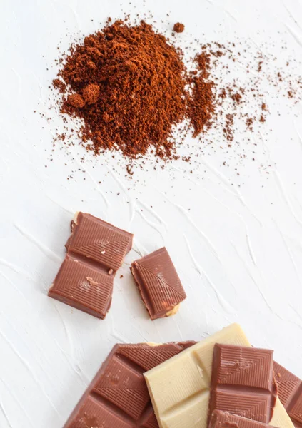 Kahve, beyaz ve sütlü çikolata. Fayans çikolata beyaz bir arka plan üzerinde.