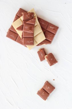 Beyaz ve sütlü çikolata. Fayans çikolata beyaz bir arka plan üzerinde.