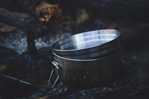 Cauldron in the mountains. Food is cooked on fire. Dishes for hiking. Traveling.