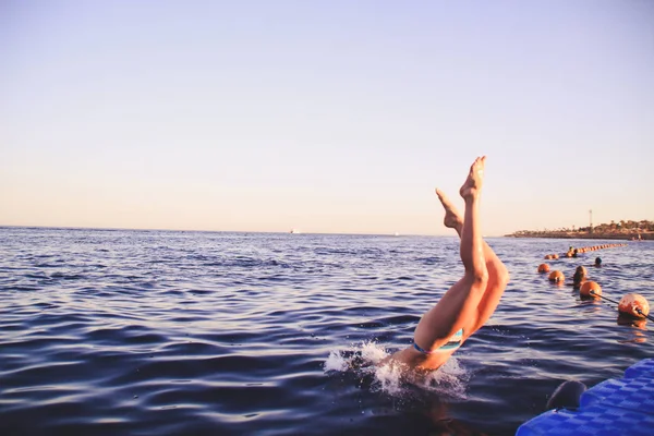 青いビキニの女の子は 水の中にダイブします エジプトの紅海で飛躍します 赤髪の女性水のかかるジャンプ後 — ストック写真