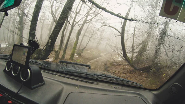 Travel by car in the mountains. Offroad The view from the window on the foggy mountains and forests of the Ukrainian Carpathians