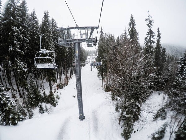 A team of friends riding in a ski resort. Snowboarders and skiers. Ukrainian Carpathian Mountains. Girl and guys.