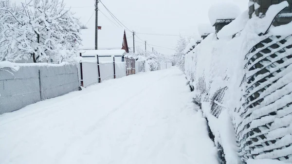 Snowy street. Fights are all in the snow. Morning after snowfall.