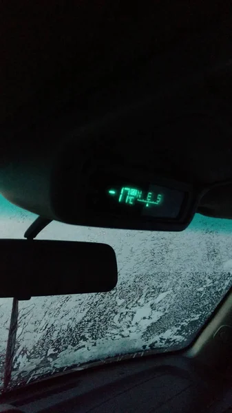 The temperature sensor in the car shows - 17 degrees Celsius. The car is in winter. Frosts Frozen window.