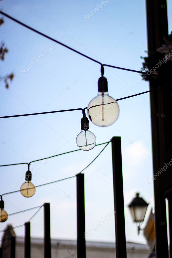 Decoration of the cafeteria. Edison incandescent lamps. Street decor Light lanterns Warm light. Day light