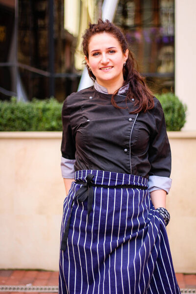 Portrait of Chef's Girl. In a kite on the street.Cooking.Crown f