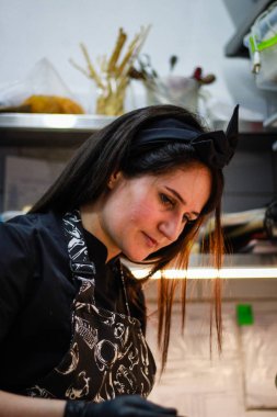 Kız şefi fesleğen peyniri ile yeşil krep rolleri hazırlanıyor