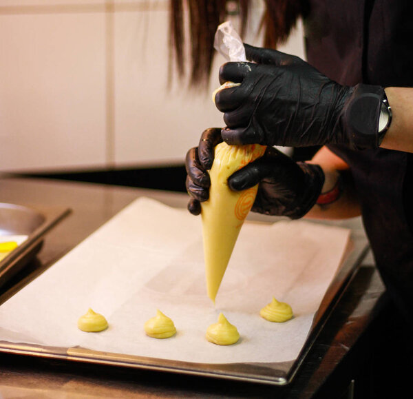 The girl's chef is preparing an eclectic pastry cake. Yellow cak
