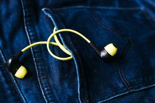 Headphones in the back pocket of jeans. Copy Space Background fo — Stock Photo, Image