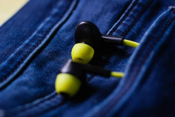 Headphones in the back pocket of jeans. Copy Space Background fo — Stock Photo, Image
