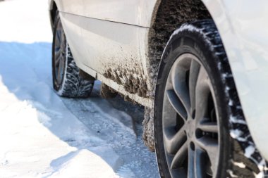 Araba karda beyaz. Karda tekerlekler üzerinde lastik. Kar