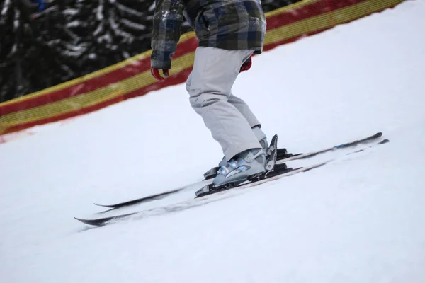 The skier rides in the snow. Splashes of snow. Snow trail in the — Stock Photo, Image