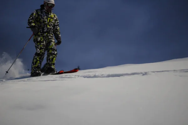 El esquiador cabalga en la nieve. Salpicaduras de nieve. Sendero de nieve en el — Foto de Stock