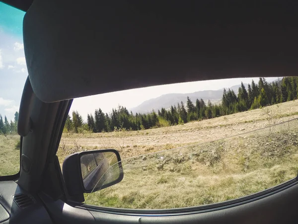 Araba penceresinden dağlara ve ormana bak. Offroa