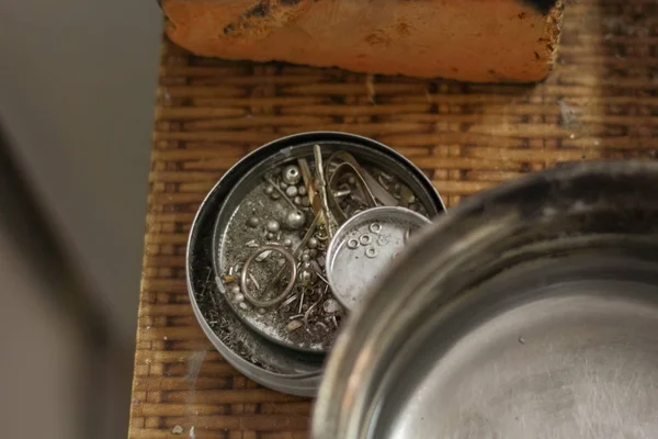 A jewelry master is working to create a silver ring