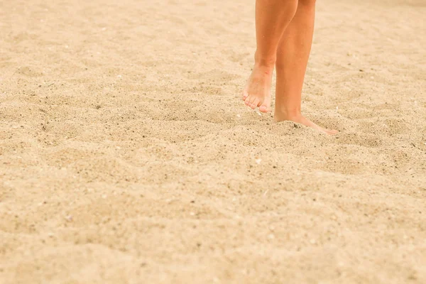 Patas femeninas en la arena. Pie humano. Mar. Publicidad — Foto de Stock
