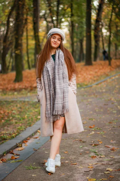 Herfst meisje portretten. Beige jas, hoed, witte sneakers. Succesf — Stockfoto