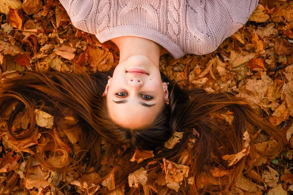 Herfst meisje portretten. Zonsondergang. Roze gebreide trui. Geel blad — Stockfoto