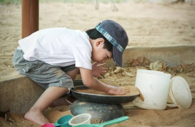 Küçük Asyalı çocuk kum havuzunda oynamayı: portre