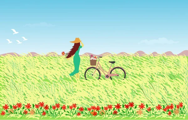 Arka plan olarak reed çiçekler, gökyüzü ve dağ bir alanda bir bisiklet konumu olan bir şapka giymiş mavi etek kadında.