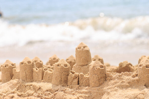 Sand castle standing on the beach. Travel vacations concept