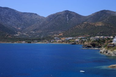 Deniz tatil köyü Bali Körfezi. Dalgalar ve şezlonglar tarafından yıkanmış dağ, kıyı, görünümlerini.